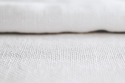 White linen fabric displaying texture and intricate weave patterns photo