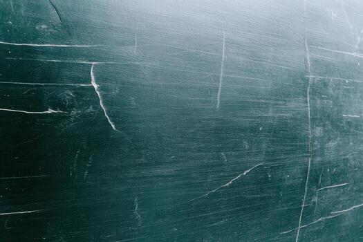 Textured dark green surface with scratches and lines in natural lighting photo