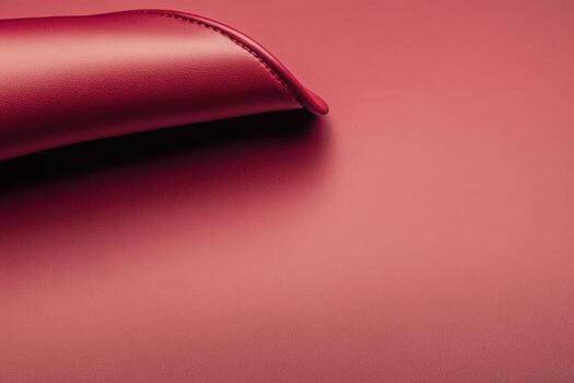 Elegant red leather texture with a curved edge on a smooth background photo