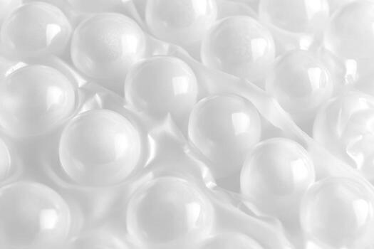 Textured surface of white bubble wrap showcasing round bubbles in detail photo