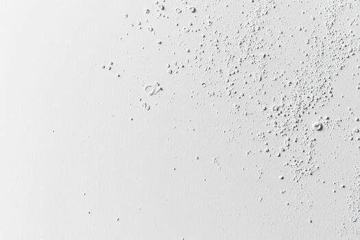 Water droplets scattered on a white surface create an artistic pattern photo