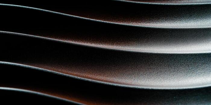 Wavy patterns of light and shadow on a textured surface in close-up view photo