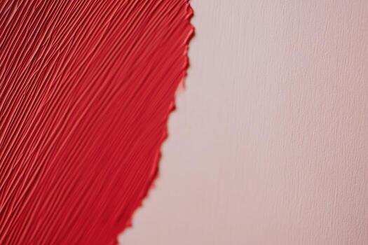 Bold red paint stroke on a smooth surface creates striking contrast photo