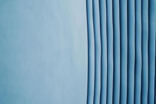 Curved patterns of blue fabric create a soothing visual effect in a modern space photo