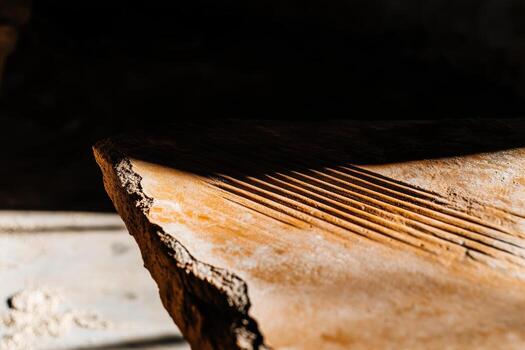 Unique textures and patterns on ancient stone slab in warm light photo