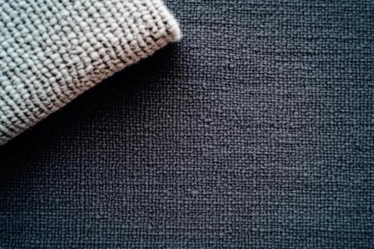Close-up view of textured fabric and rolled material on a dark surface photo