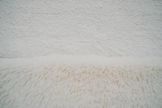 Wall texture and soft rug combination in a cozy interior setting photo