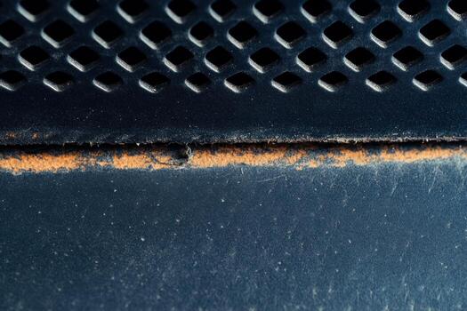 Rust and wear marks on metal surface in close-up view indoors photo