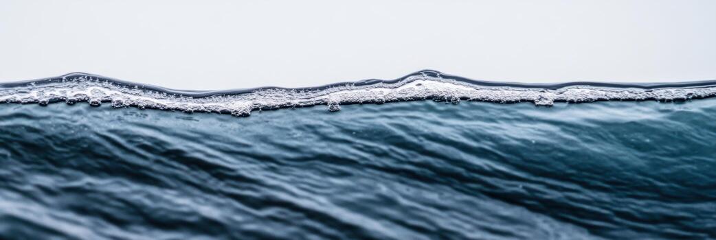 Waves gently cresting against a calm ocean surface at dawn's light photo