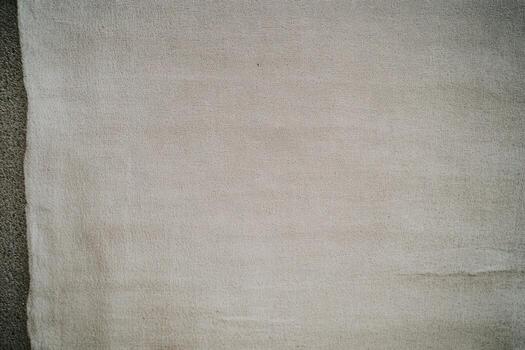 Textile fabric spread out on a surface while in the process of being prepared photo