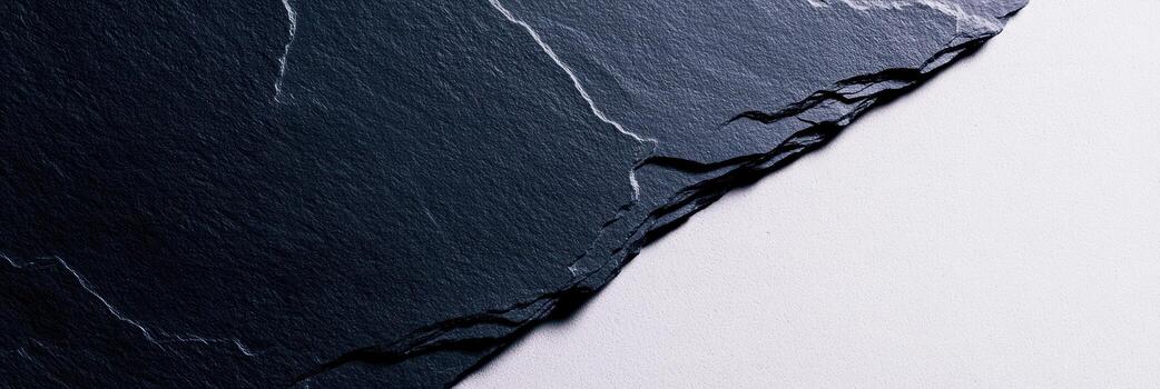 Dark textured slate stone piece on white background providing natural elegance photo