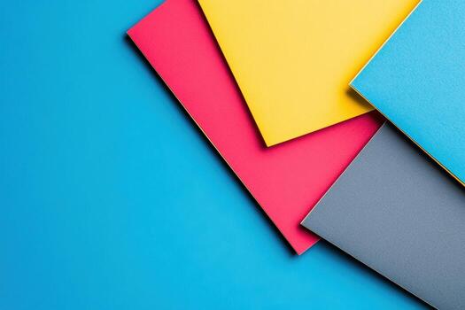 Colorful sheets of paper arranged on blue background for creative projects photo