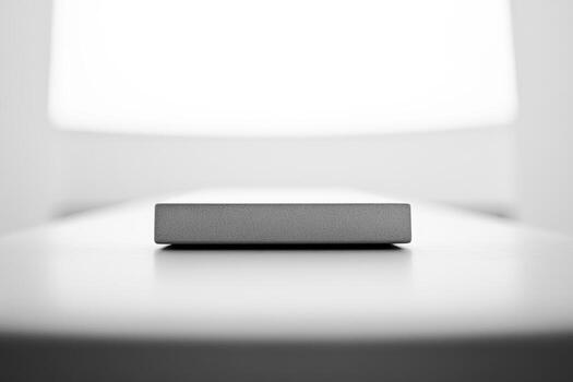 Simple white rectangular object on a smooth surface in minimal setting photo