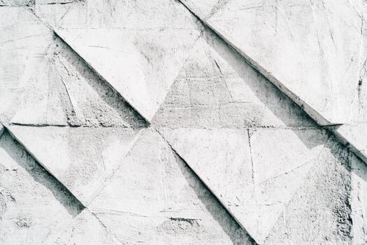 Unique textured wall featuring abstract triangular patterns in natural light photo