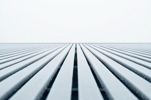 Perspective of parallel lines on a textured surface against a bright sky photo