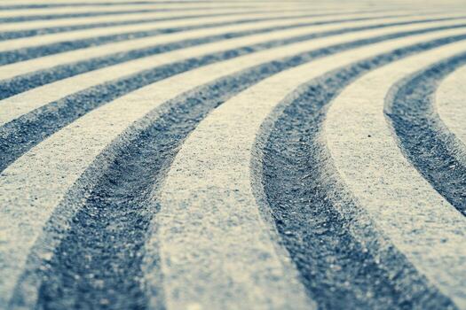 Unique patterns of curved lines on a textured concrete surface at dawn photo