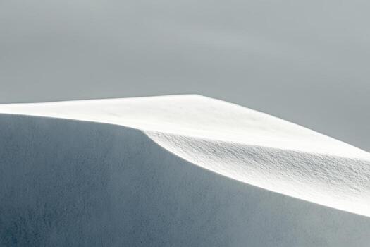 Snowy landscape contours create serene visual harmony in winter light photo