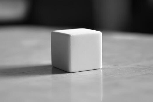 Minimalistic white cube placed on a smooth surface captures simplicity in design photo