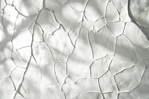 Cracked white wall texture showcasing natural patterns and shadows photo