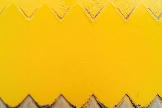 Bright yellow textured surface with chevron pattern during daylight photo