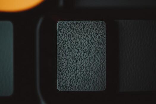 Close-up view of a textured keyboard key on a modern device at night photo