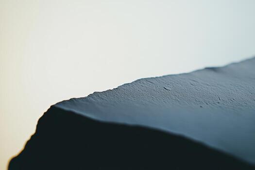 Close-up view of a textured rock against a soft gradient background photo