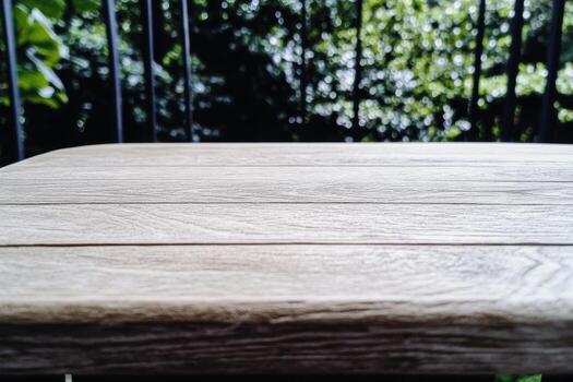 Wooden table in a serene outdoor setting surrounded by greenery photo