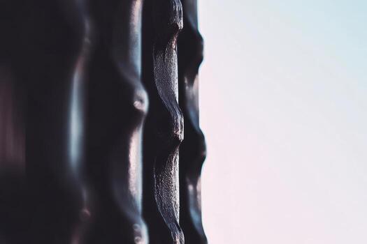 Close-up view of textured black surface against a light backdrop photo