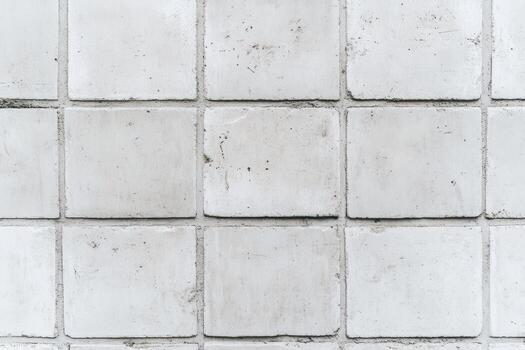 Concrete tile wall with square patterns showing wear and texture photo