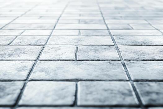 Textured gray tiles arranged in a neat pattern on a floor surface photo