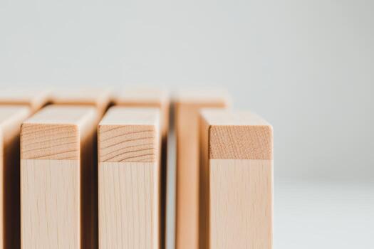 Wooden blocks arranged in a neat row on a light background with soft lighting photo