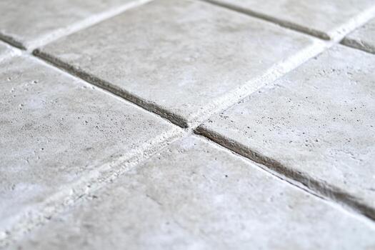 Light gray textured tiles arranged in a geometric pattern on the floor photo