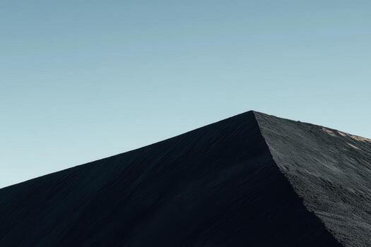 Mountain peak under clear sky captures serene beauty with sharp angles photo