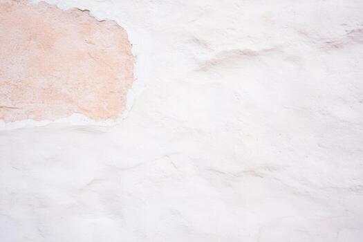 Textured wall with subtle color variations in a sunlit setting photo