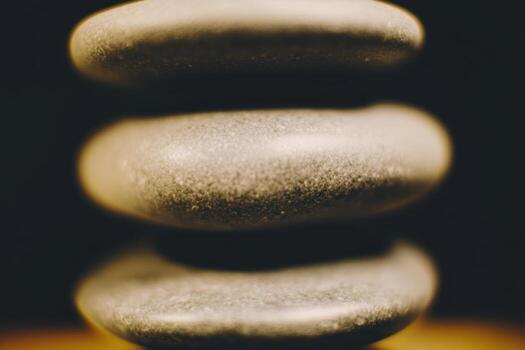 Stones stacked in a balanced formation on a wooden surface photo