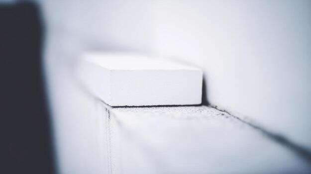 Close-up view of a white chalk piece resting on a ledge in a classroom photo