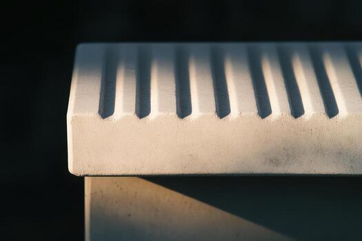 Close-up view of textured concrete surface with shadows and light play photo