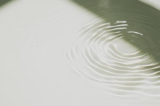 Calm water surface creating gentle ripples under natural light photo