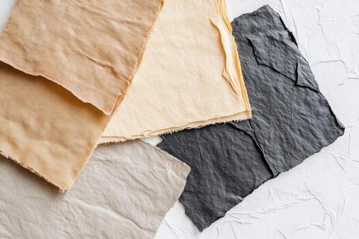 Textiles of various colors and textures arranged on a neutral background photo