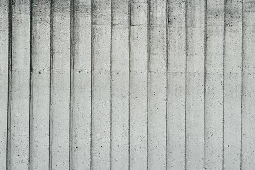 Textured concrete wall with vertical lines and patterns in urban setting photo