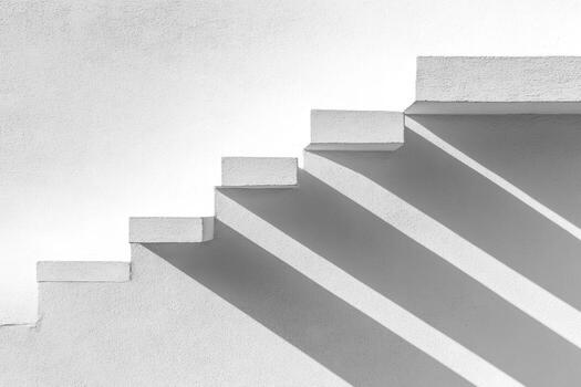 Shadows cast by stairs create striking geometric patterns on a wall photo