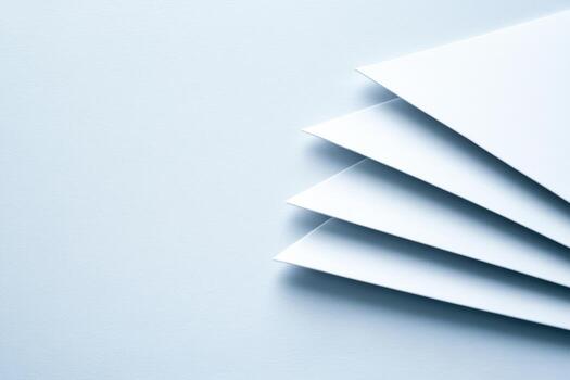 Stacked blank sheets of paper arranged neatly on a light surface photo