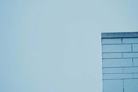 Building corner against a cloudy sky in an urban setting photo