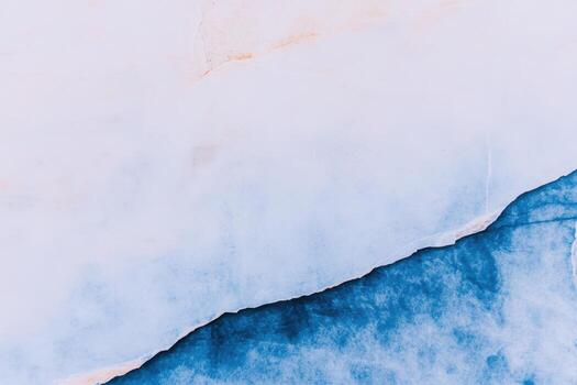 Blue and white textured wall creating an abstract design in sunlight photo