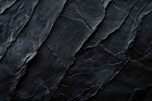 Dark textured slate covering a surface with layered patterns and lines photo