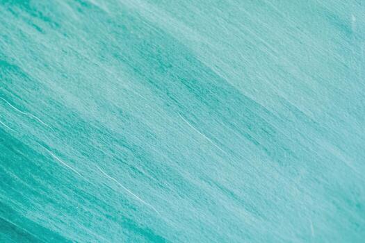 Turquoise water surface with gentle wave patterns under sunlight photo