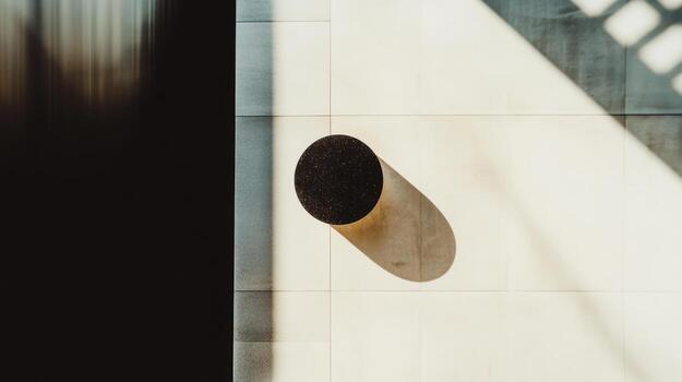 Circular object casting a shadow in a minimalist indoor space photo