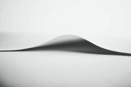Soft fabric draping elegantly on a flat surface creating gentle curves photo