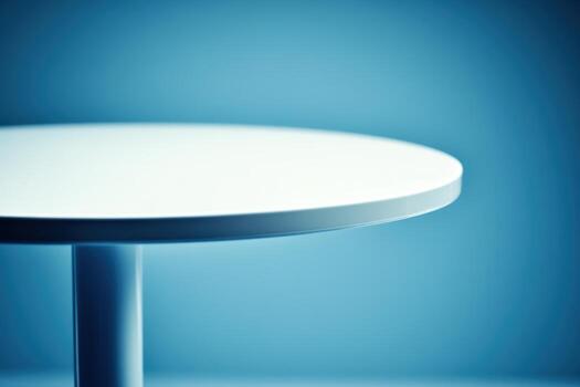 Modern round table against a blue background in a minimalistic setting photo