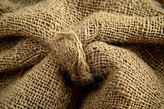 Textured burlap fabric showing a knotted tie in natural lighting photo